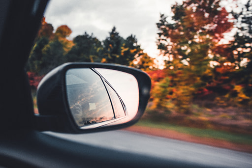 Rear view mirror with fall foliage | Fall bucket list 10 impactful fall activities