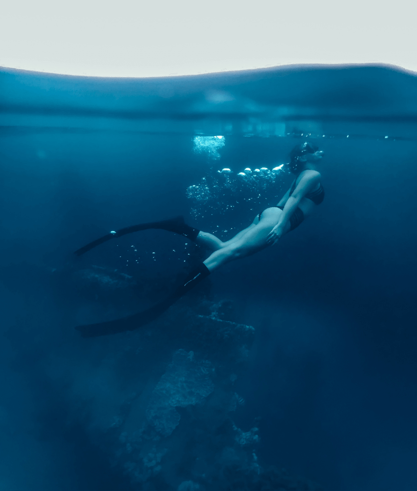 Woman freediving in the blue water